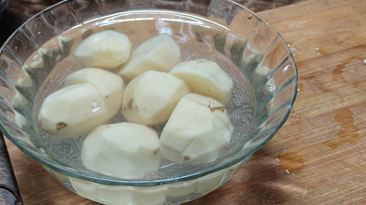 %Niramish Khichuri Cooking process step 6 - cutting and soaking potatoes