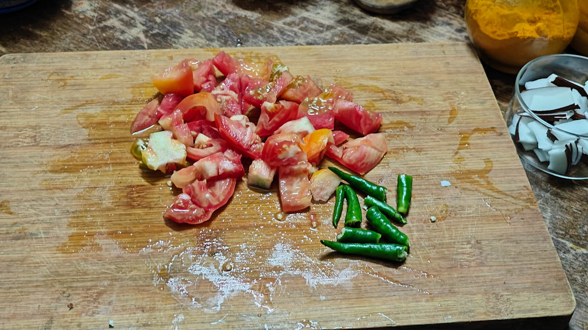 %Niramish Khichuri Cooking process step 7 - cutting tomatoes and green chilli